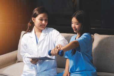 Tanımlanamayan fiziksel terapi sırasında mavi el ağırlığı kullanır