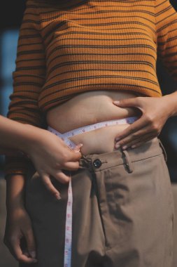 Şişman karnına dokunup sıkarken çekilmiş bir fotoğraf..