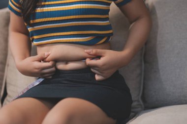 Şişman karnına dokunup sıkarken çekilmiş bir fotoğraf..