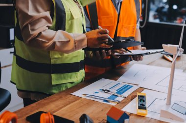 Mühendisler proje türlerinin yapısal analizi ve planları üzerinde çalışmalara yardım ediyorlar..