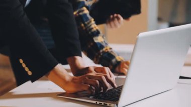 Kapat. Genç iş adamı ofiste dizüstü bilgisayar kullanıyor..