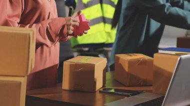 Paket kutusuyla çalışan üniformalı bir teslimatçı.