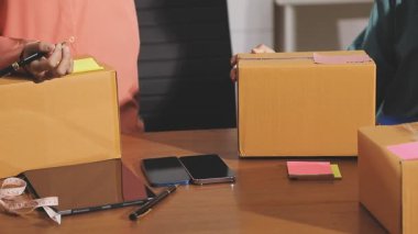 Paket teslimatı için paket kutusu hazırlayan adam.