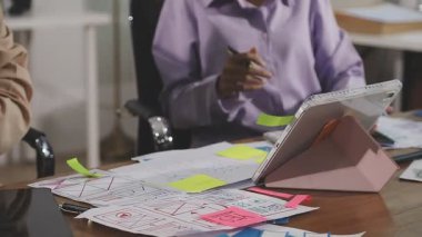 Genç bir kadın ofiste bir proje üzerinde çalışıyor.