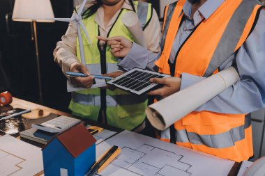 Mühendisler proje türlerinin yapısal analizi ve planları üzerinde çalışmalara yardım ediyorlar..