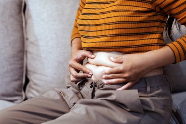 Şişman karnına dokunup sıkarken çekilmiş bir fotoğraf..