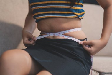 Şişman karnına dokunup sıkarken çekilmiş bir fotoğraf..