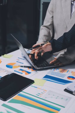 Muhasebe şirketi kazançlı nakit akışı için finansman ve vergilendirme planlaması, ofiste çalışan denetçi ve muhasebeci ekibi, mali verileri ve muhasebe kayıtlarını hesap makinesiyle analiz eder.