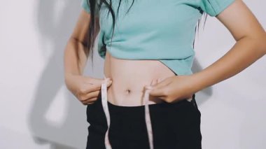 Belini ölçen Asyalı kadınlar.