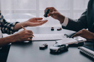 Araba satıcısı, satın alma sözleşmesini yasal olarak imzalayan müşterilere anahtar verdi, araba satışlarının başarıyla tamamlanması, satın alma sözleşmesi ve anahtar teslimatı..