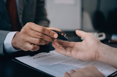 Araba satıcısı, satın alma sözleşmesini yasal olarak imzalayan müşterilere anahtar verdi, araba satışlarının başarıyla tamamlanması, satın alma sözleşmesi ve anahtar teslimatı..