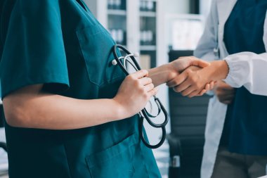 Medical team meeting analyzing blood test results in hospital laboratory. Doctors and scientists in lab coats are having a discussion about blood test result, holding test tubes and taking notes.
