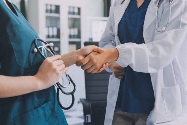 Medical team meeting analyzing blood test results in hospital laboratory. Doctors and scientists in lab coats are having a discussion about blood test result, holding test tubes and taking notes.