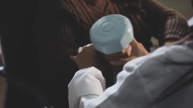 woman in a white shirt with a cup of coffee on the background of the window