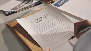 close - up image of a businessman signing contract at the desk at the office in the office.