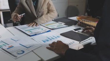 business colleagues discussing and analyzing financial charts