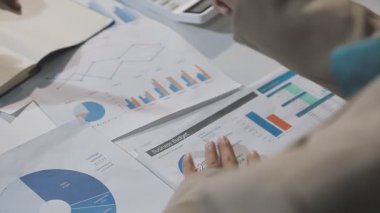 businesswoman pointing at financial report