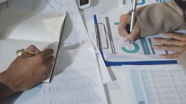 businessman analyzing graph on desk in office