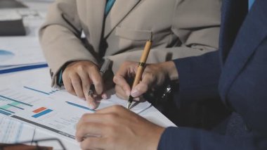 business team working together and analyzing financial data on laptop