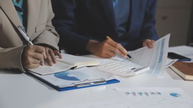 business people discussing financial charts and graphs on desk in office. teamwork concept
