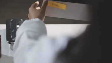 businessman using a smartphone to do list on the desk in the office. business concept