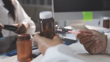 close up. a scientist is making notes on the laboratory table