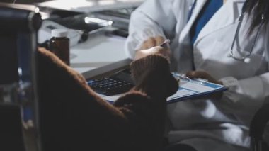female doctor writing prescription in a modern office