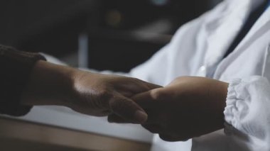 close up of a doctor hand holding the patient 's hand