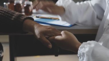 young woman and man in a suit holding a hand