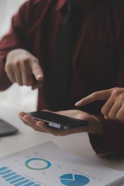 Hesap makinesi ve dizüstü bilgisayarı kullanarak ahşap masa, vergi, muhasebe, istatistik ve analitik araştırma konseptine matematik finansmanı sağlayan İş kadını kapat