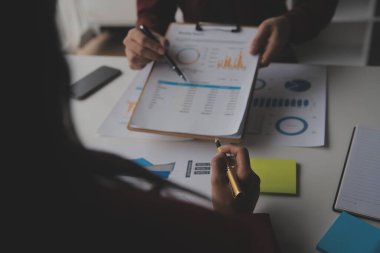 Hesap makinesi ve dizüstü bilgisayarı kullanarak ahşap masa, vergi, muhasebe, istatistik ve analitik araştırma konseptine matematik finansmanı sağlayan İş kadını kapat