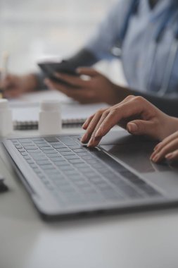 Doctors, nurse or laptop in night teamwork, medical research or surgery planning in wellness hospital. Talking, thinking or healthcare women on technology for collaboration help or life insurance app