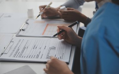 Doctors, nurse or laptop in night teamwork, medical research or surgery planning in wellness hospital. Talking, thinking or healthcare women on technology for collaboration help or life insurance app