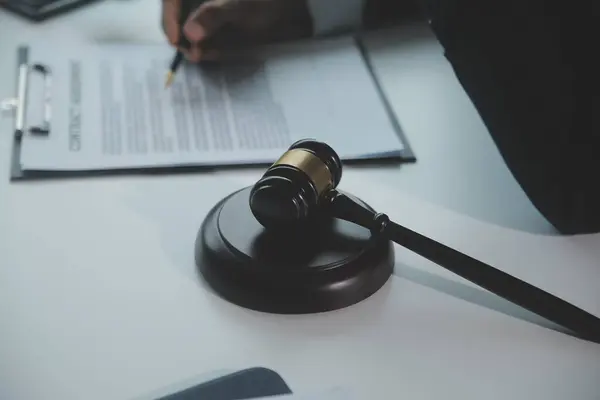 stock image Business and lawyers discussing contract papers with brass scale on desk in office. Law, legal services, advice, justice and law concept picture with film grain effect