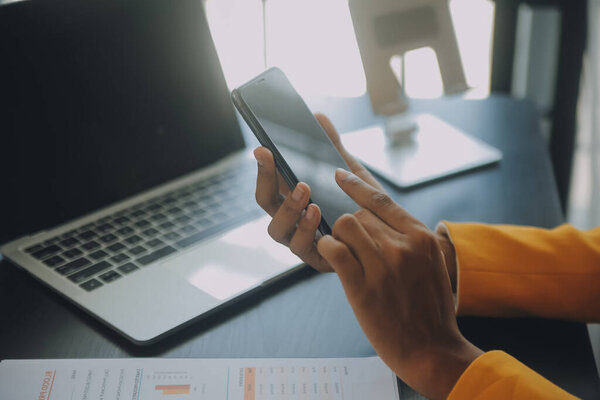 Creative Asian young woman working on laptop in her studio