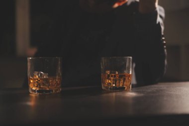 Kutlama gecesi, bardağa viski dök. Kutlamaya gelen arkadaşlarına ver.