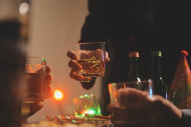 Kutlama gecesi, bardağa viski dök. Kutlamaya gelen arkadaşlarına ver.