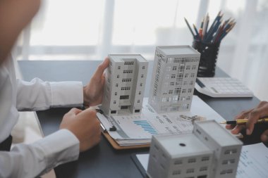 Emlakçı ve satış yöneticisi takım analiz Satılık Kiralık kira sözleşmesinin fiyatlandırma için ipotek kredi teklif ve ev sigortası ile ilgili anlaşma, Satın almak.
