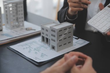 Emlakçı ve satış yöneticisi takım analiz Satılık Kiralık kira sözleşmesinin fiyatlandırma için ipotek kredi teklif ve ev sigortası ile ilgili anlaşma, Satın almak.