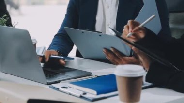 İş adamı ve iş kadını modern ofiste laptopla çalışmayı tartışıyor