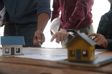 Diverse Team of Specialists Use Laptop on Construction Site. Real Estate Building Project with Engineer Investor and Businessman Checking Area, working on Civil Engineering, Discussing Strategy Plan