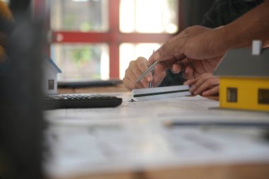 Diverse Team of Specialists Use Laptop on Construction Site. Real Estate Building Project with Engineer Investor and Businessman Checking Area, working on Civil Engineering, Discussing Strategy Plan