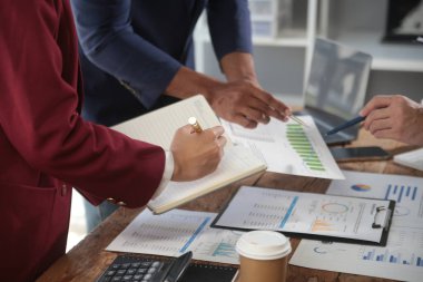 İş ekibi toplantısı yeni bir başlangıç projesi üzerinde çalışıyor, verileri tartışıyor ve analiz ediyor çizelgeler ve grafikler. Dijital tablet, hesap makinesi, dizüstü bilgisayar kullanımı, iş finans ve muhasebe kavramı.