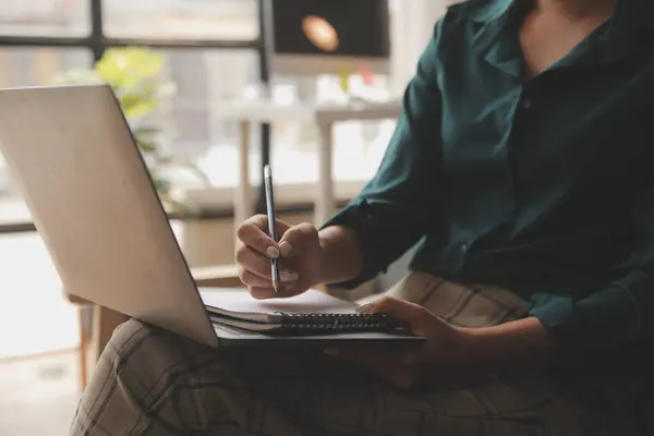 stock image Distracted from work worried young woman sitting on couch with laptop, thinking of problems. Pensive unmotivated lady looking at window, feeling lack of energy, doing remote freelance tasks at home.