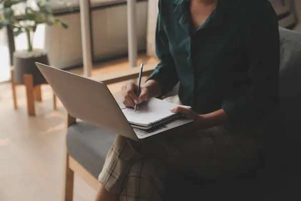 stock image Distracted from work worried young woman sitting on couch with laptop, thinking of problems. Pensive unmotivated lady looking at window, feeling lack of energy, doing remote freelance tasks at home.