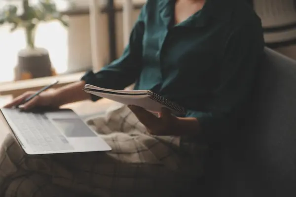 stock image Distracted from work worried young woman sitting on couch with laptop, thinking of problems. Pensive unmotivated lady looking at window, feeling lack of energy, doing remote freelance tasks at home.