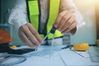 Mühendisler toplantı yapıyor ve ofiste bir planı tartışıyorlar. Mühendislik araçları ve inşaat konsepti
