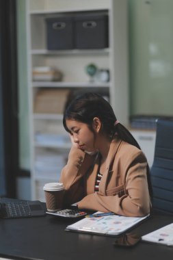 Asyalı kadınlar dizüstü bilgisayarda çalışırken streslidirler, ofiste başı ağrıyan Asyalı iş kadını, işte hasta hissederler, yer kopyalayabilirler.