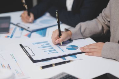 Close up of Business team analyzing income charts and graphs with modern laptop computer. Business analysis and strategy concept.