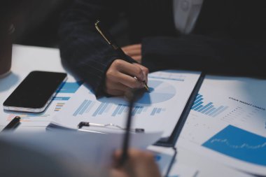 Close up of Business team analyzing income charts and graphs with modern laptop computer. Business analysis and strategy concept.